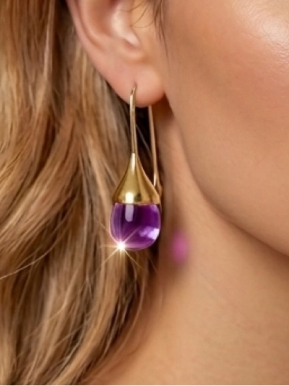 New earrings featuring a teardrop-shaped purple stone with gold-tone hardware